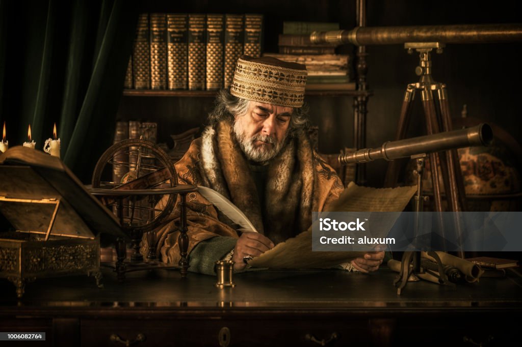 Astronomer writing on parchment with feather pen Ancient Stock Photo
