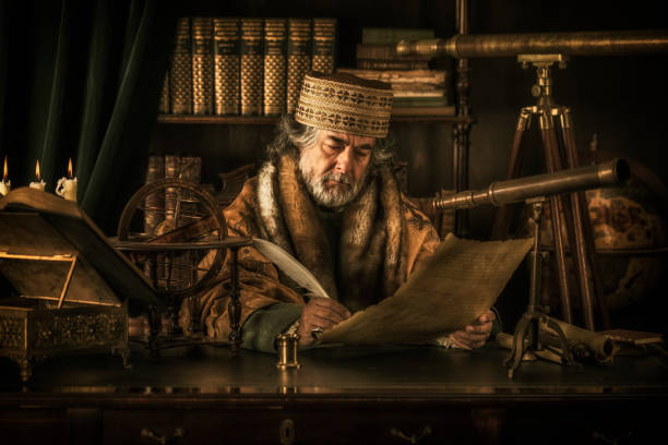 Astronomer writing on parchment with feather pen Astronomer writing on parchment with feather pen astronomer photos stock pictures, royalty-free photos & images