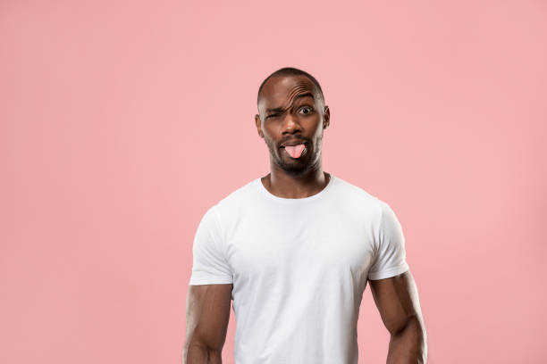 istock The squint eyed man with weird expression isolated on pink 1006082782