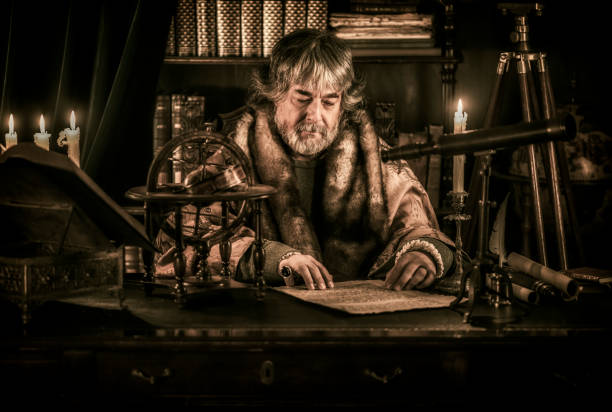 istock Scholar reading old text written on parchment paper 1006082794