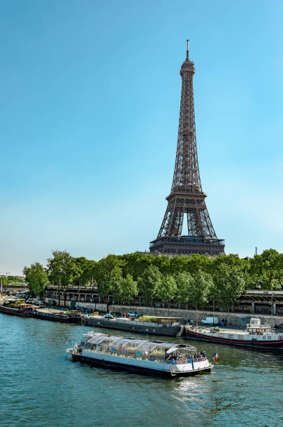 istock Landscape in Paris. Eiffel Tower, cruise boat on the Seine, vertical 1006085876