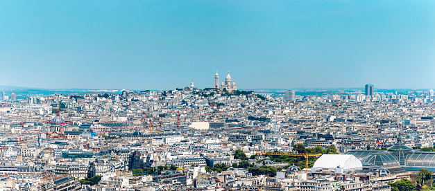 Aerial view of Paris rooftops including Sacre Coeur in Montmartre. Sunny morning in the City of Light