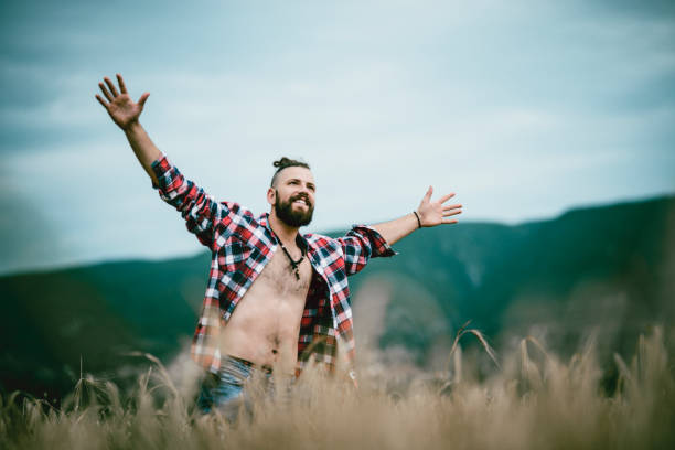 Handsome Male Walking Through Fields And Enjoying Freedom