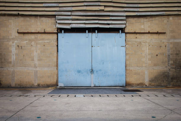 istock Large steel doors of old warehouses are closed. 1006091982