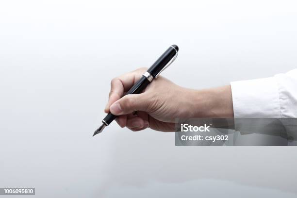 A Hand Holding A Fountain Pen Stock Photo - Download Image Now - Fountain Pen, Hand, Businessman