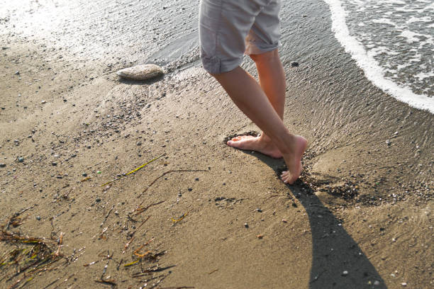 istock Young woman walking on the beach 1006098072