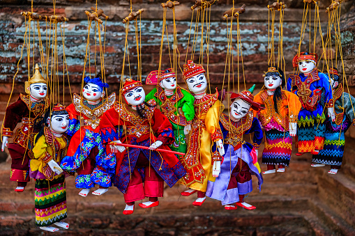Souvenirs for tourists - colorful puppets for sale in one of ancient temples of Bagan, Myanmar (Burma).