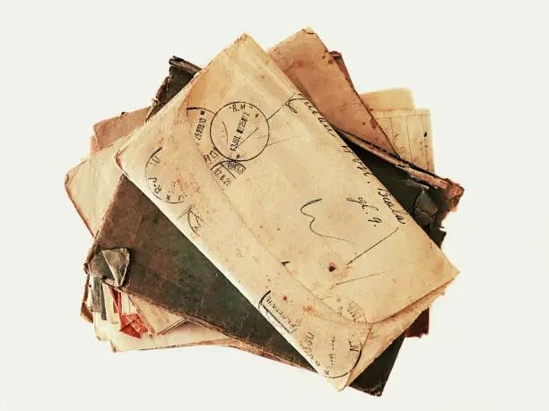 Isolated image of an overhead  pile of old letters and envelopes from the beginning of the 20th century