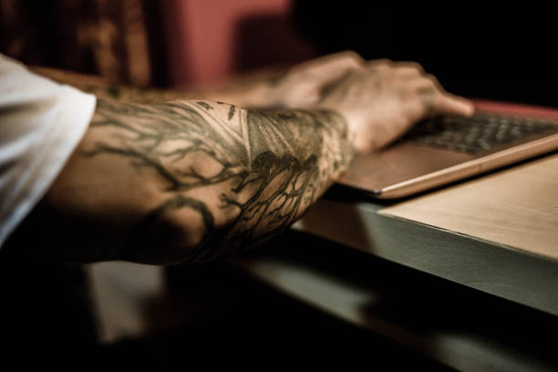 istock The tattoo master works on a lap top 1006107136