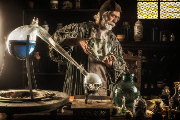 The Alchemist Medieval alchemist working in his laboratory distillation photos stock pictures, royalty-free photos & images