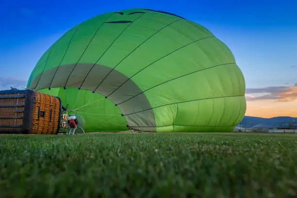 Hot air ballon being prepared for early morning launch.