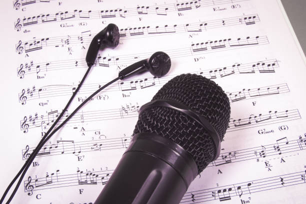 istock Microphone on music sheets. The concept of creating music. 1006119342