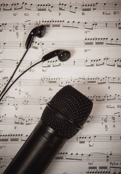 istock Microphone on music sheets. The concept of creating music. 1006124826