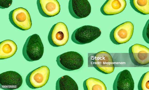 Fresh Avocado Pattern On A Green Background Stock Photo - Download Image Now - Avocado, Backgrounds, Food