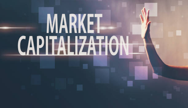 istock Market Capitalization with a hand in a dark background 1006125592