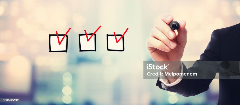 Checklist with businessman Checklist with businessman on blurred abstract background Checklist Stock Photo