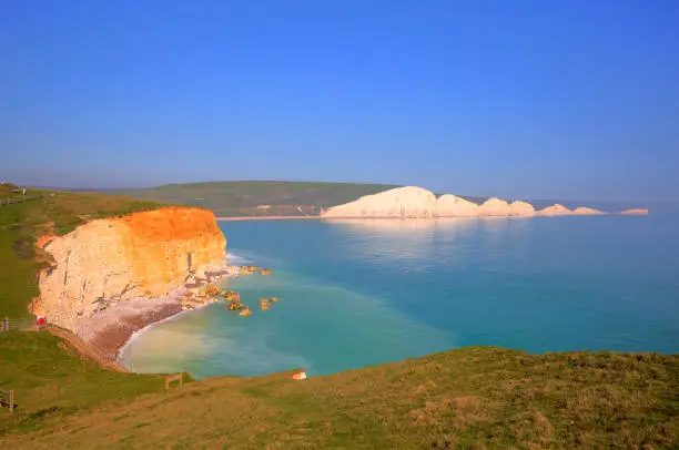 Seven Sisters chalk cliffs South Downs East Sussex uk between Seaford and Eastbourne in southern England tourist attraction on a beautiful day with blue sky and sea