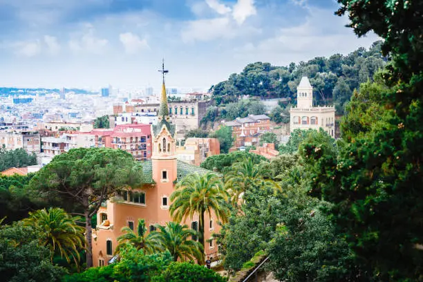 Photo of Barcelona landmarks, Spain. House where lived famous and outstanding architect Antonio Gaudi placed in park Guell park in Barcelona, Spain. Extremely popular travel destination in Barcelona, Europe.