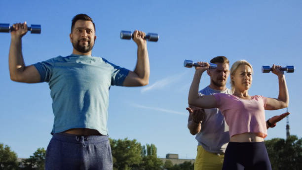 istock Man training adult couple on field 1006133502
