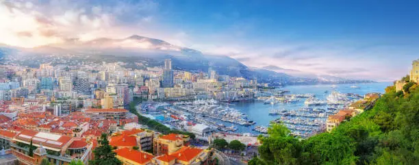 Photo of Principality of Monaco. Beautiful panoramic view on Monaco, golden hour scenery. View on apartment building, casino, great port with luxury yachts. Monaco is popular travel destination, wealth symbol.