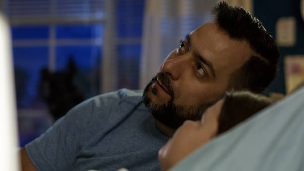 istock Man with girl in bed telling story 1006143538