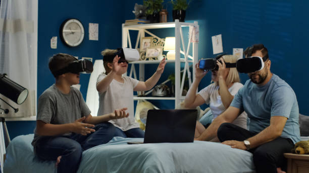 istock Family in VR glasses sitting on bed 1006143840
