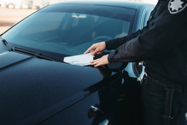 istock Male policeman in uniform writes a fine on road 1006148668