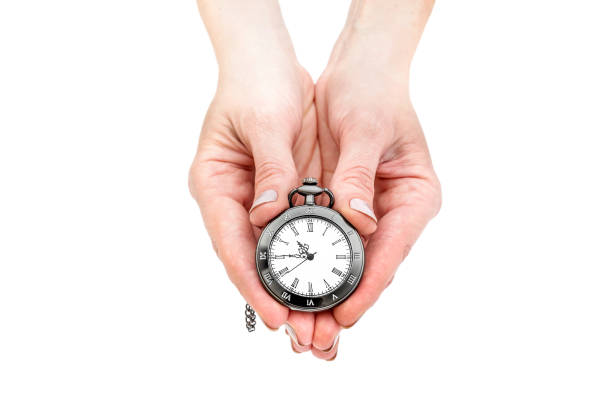 istock Woman's hands holding pocket watch. Isolated on white. 1006158032