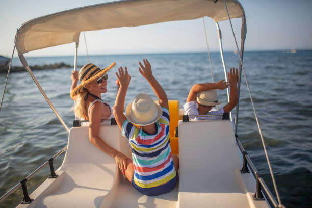 istock Mother and two sons on a pedal boat 1006179320