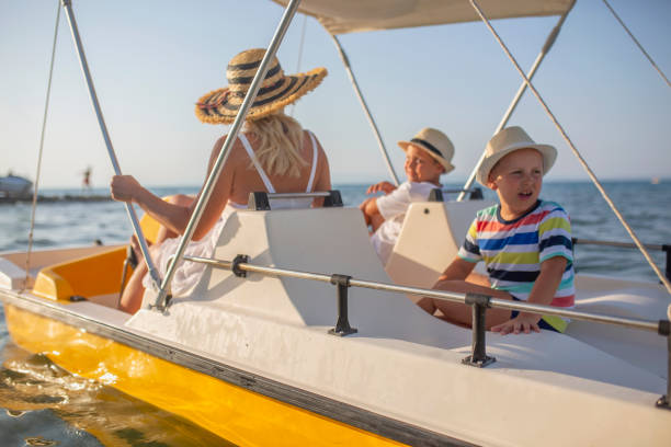 istock Mother and two sons on a pedal boat 1006185658
