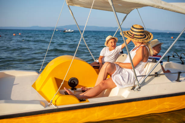 istock Mother and two sons on a pedal boat 1006185774