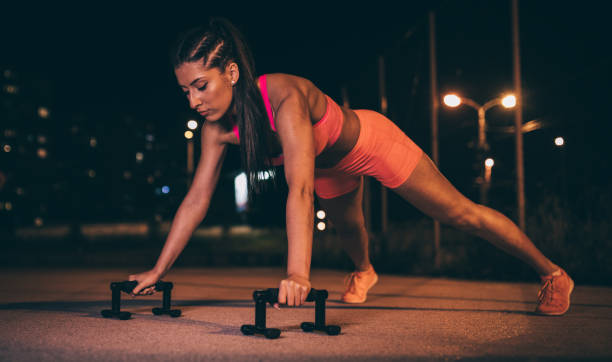 istock Young woman doing push-ups outdoors 1006185848