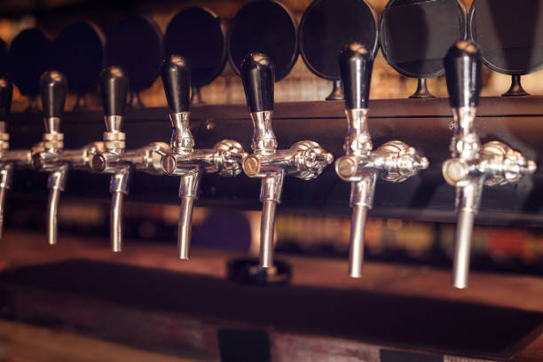 istock Beer tap row. Beer taps in bar. 1006186762