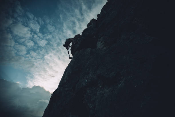 istock Man with prosthetic leg free rock climbing 1006191792