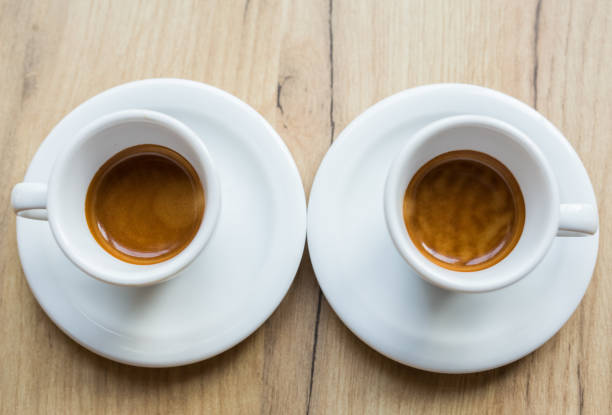 istock Two white cups of coffee on a table 1006193586