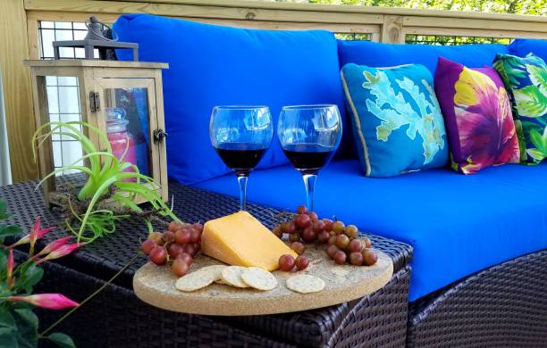 istock Red Wine With Grapes and Cheese Wedge in a Tropical Setting 1006201004