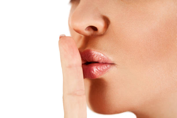 istock Woman finger close to the lips 1006201444