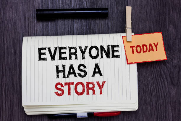 istock Handwriting text writing Everyone Has A Story. Concept meaning Background storytelling telling your memories tales Written paper on wooden desk paper clip grip note with red words black pen. 1006205756
