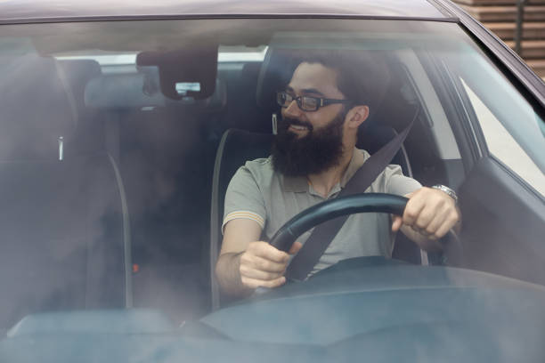 istock Happy driver with safety belt fastened 1006208888