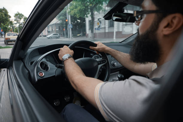 istock Modern casual bearded man driving a car 1006208946