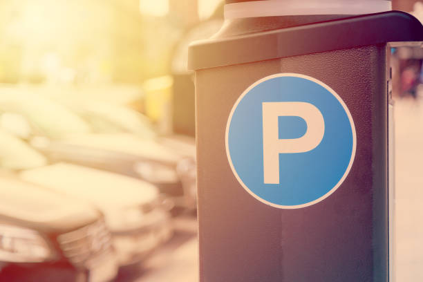 Blue parking sign with blurred cars in the background in Stockholm, Sweden. Toned image Blue parking sign with blurred cars in the background in Stockholm, Sweden. Toned image. parking meter stock pictures, royalty-free photos & images