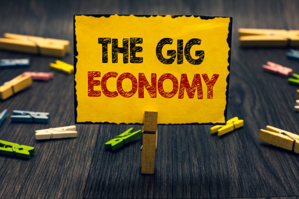 Word writing text The Gig Economy. Business concept for Market of Short-term contracts freelance work temporary Blacky wooden desk laid paper clip randomly one hold yellow board with text. Word writing text The Gig Economy. Business concept for Market of Short-term contracts freelance work temporary Blacky wooden desk laid paper clip randomly one hold yellow board with text independence document agreement contract stock pictures, royalty-free photos & images