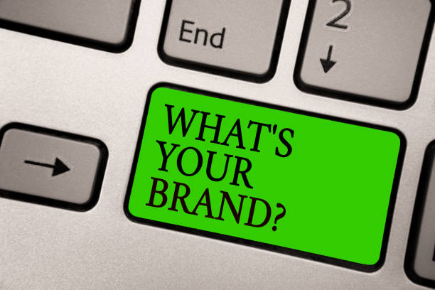 istock Writing note showing What s is Your Brand question. Business photo showcasing Define Individual trademark Identify Company Silver grey computer keyboard green button with black letters. 1006219444