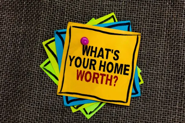 Text sign showing What s is Your Home Worth question. Conceptual photo Value of a house Property Cost Price Rate Black bordered different color sticky note stick together with pin on jute sack