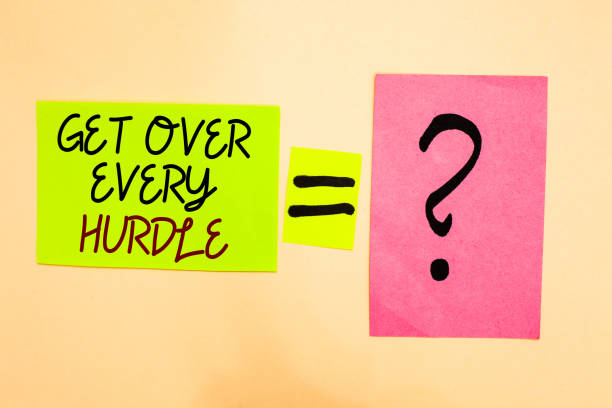 istock Writing note showing Get Over Every Hurdle. Business photo showcasing Overcome any obstacle problem trouble adversities Written on green sticky note on yellow and question mark on pink paper. 1006220276