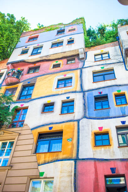 Hundertwasser house with a garden upstairs in Vienna, Austria Beautiful colorful Hundertwasser house with a garden upstairs in Vienna, Austria hundertwasser haus in vienna austria stock pictures, royalty-free photos & images