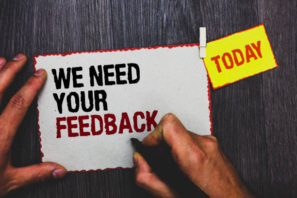 istock Handwriting text writing We Need Your Feedback. Concept meaning Give us your review thoughts comments what to improve Hand grip black marker writing text paperclip stick written page woody deck. 1006225574