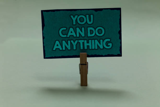 istock Writing note showing You Can Do Anything. Business photo showcasing Motivation for doing something Believe in yourself paperclip grip black lined green page with outlines grey background. 1006225642