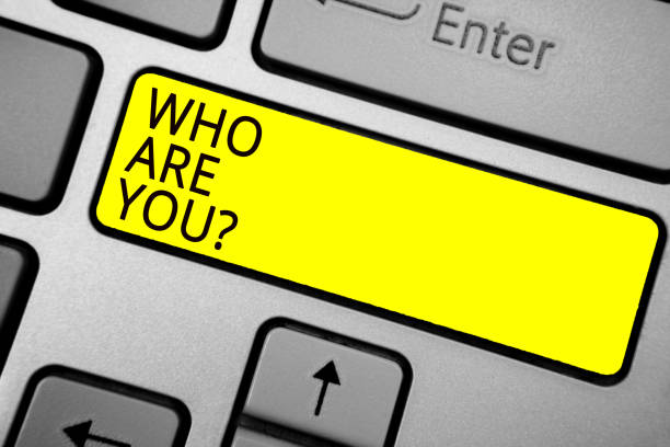 istock Handwriting text writing Who Are You question. Concept meaning Identify yourself description personal characteristics Ashy computer keyboard with yellow button black color texts. 1006235378