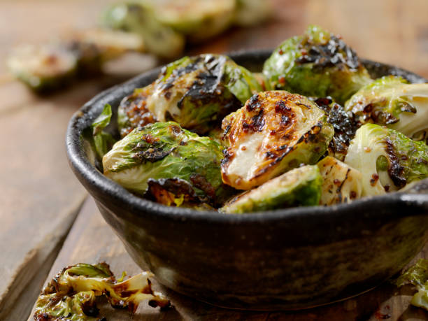 BBQ Brussels Sprouts with Grainy Mustard, Honey Glaze BBQ Grilled Brussels Sprouts with Grainy Mustard, Honey Glaze roasted stock pictures, royalty-free photos & images